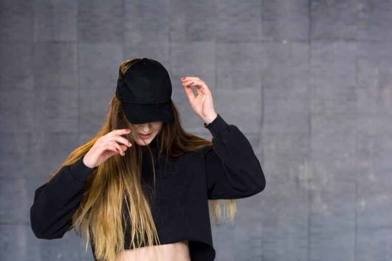 Woman dancer in black cap.
